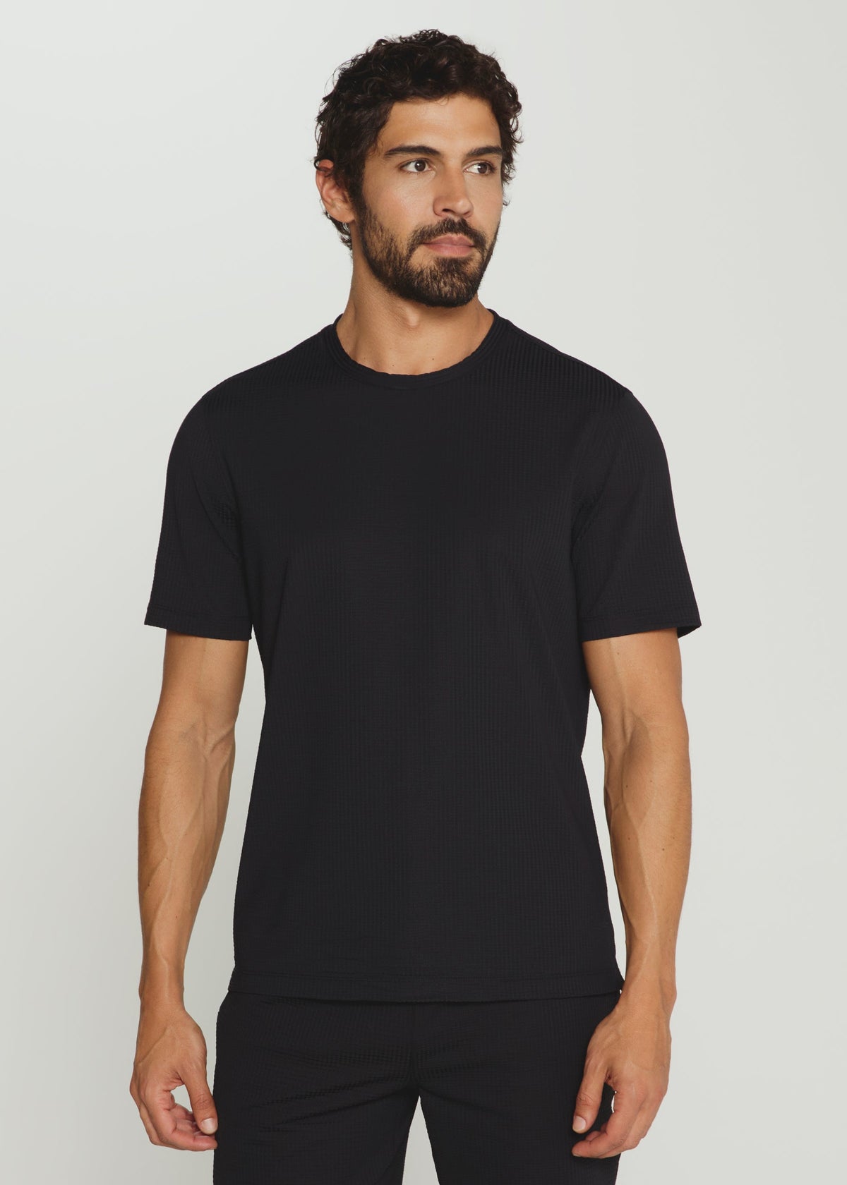 Man wearing a black t-shirt against a plain background