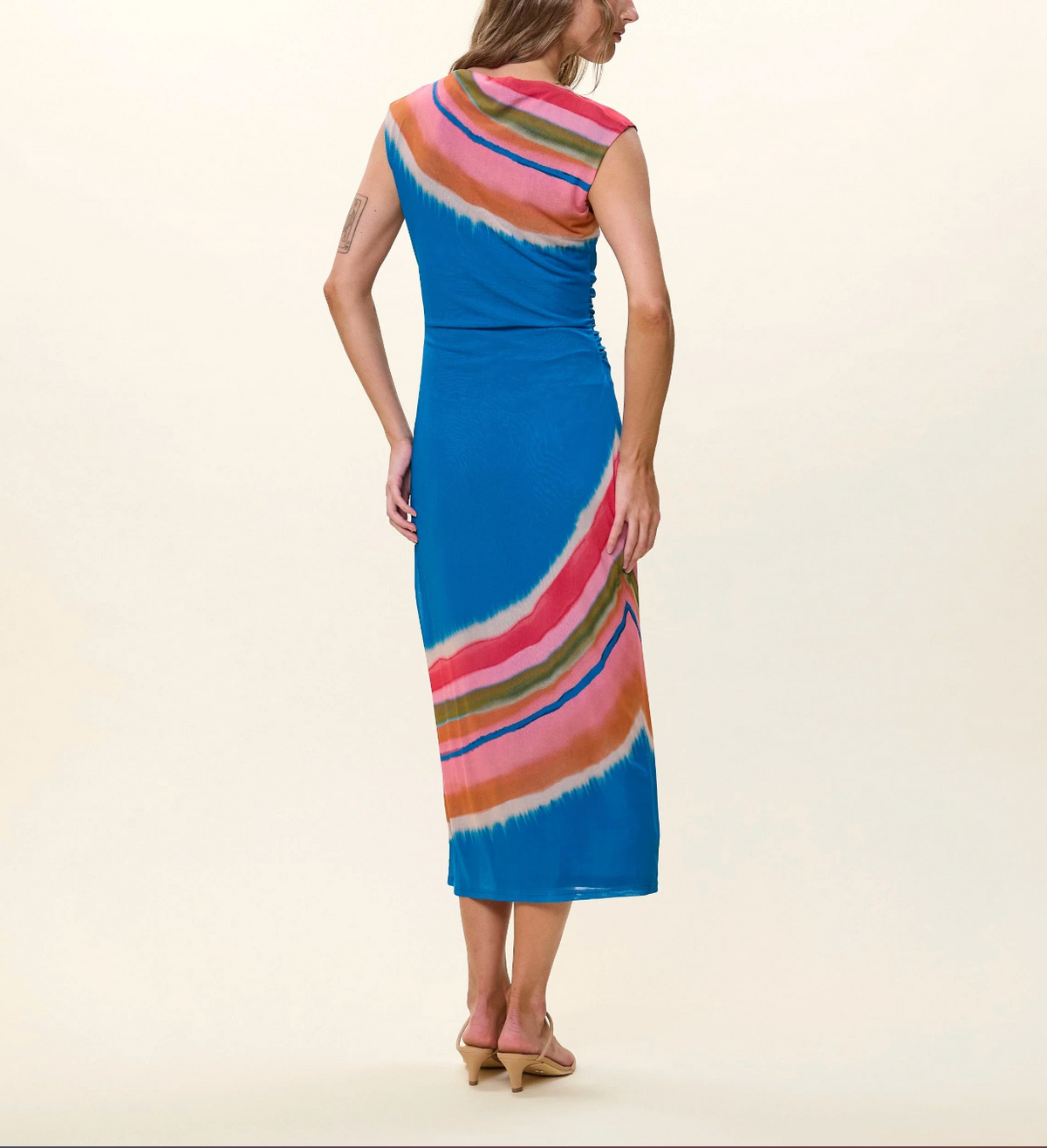 Woman wearing a colorful dress with a white background