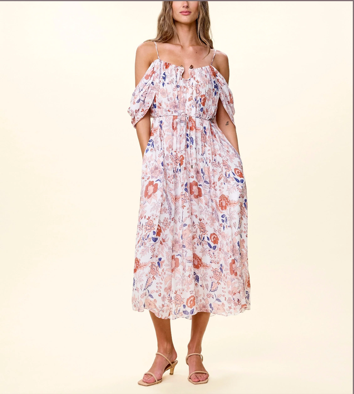 Woman wearing a floral dress on a plain background