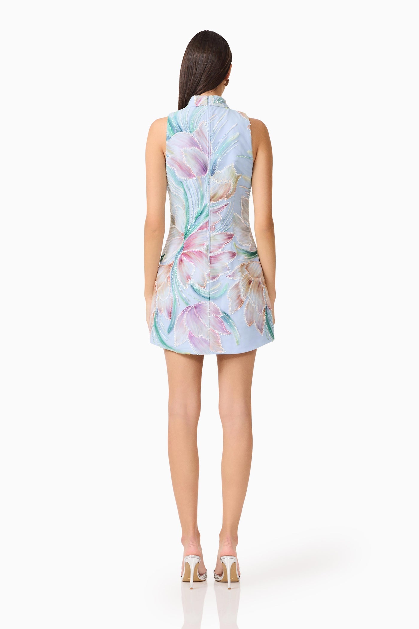 Woman wearing a floral dress on a white background