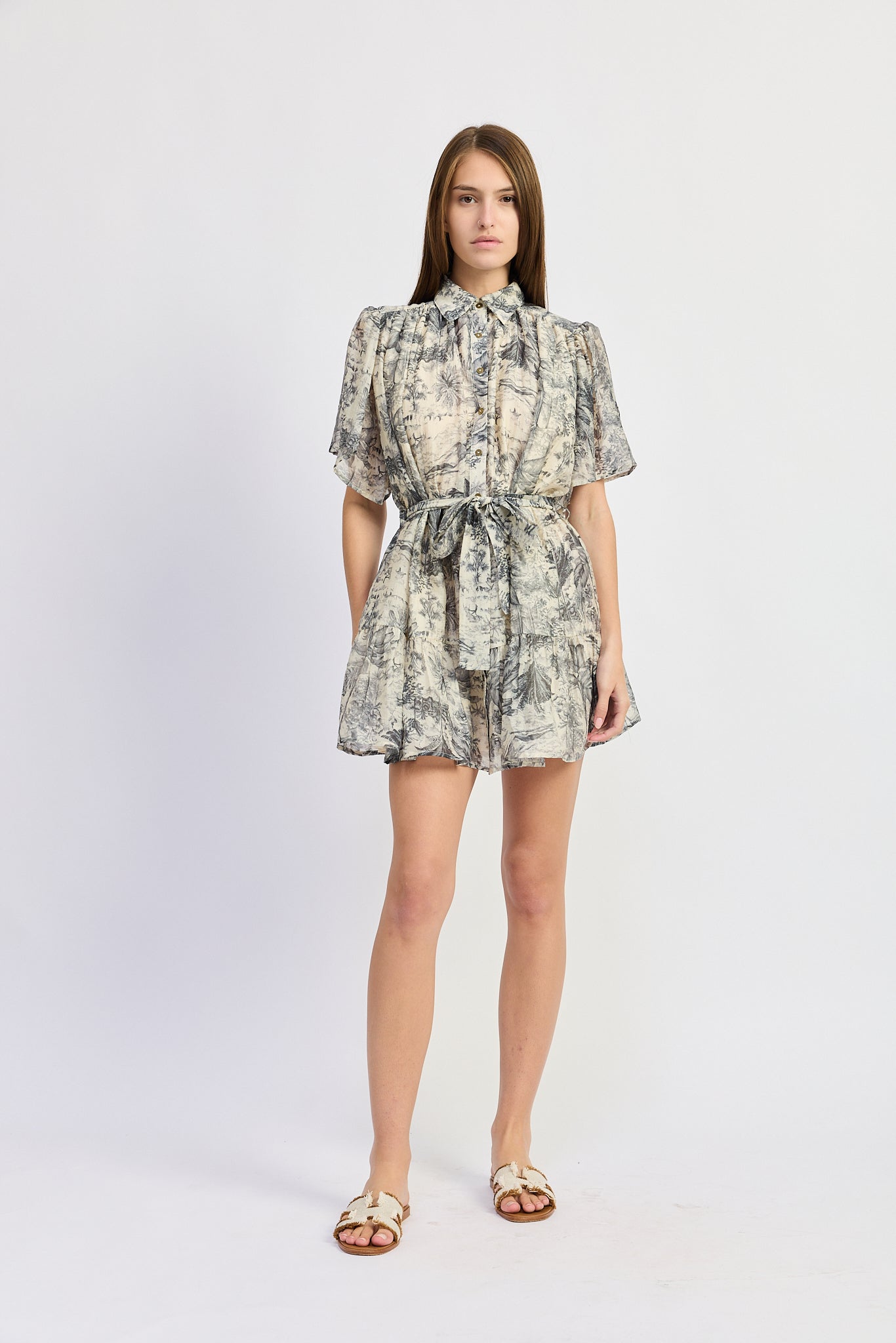 Woman wearing a patterned dress on a white background