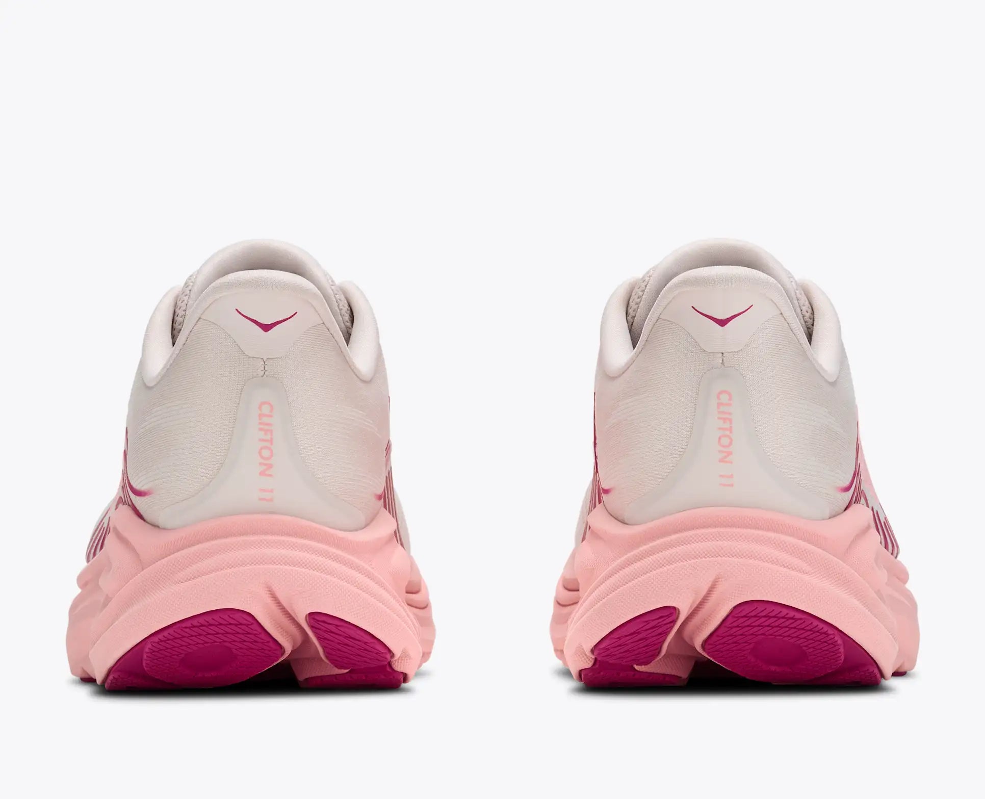 Pink and gray running shoes with visible Nike logo on a white background
