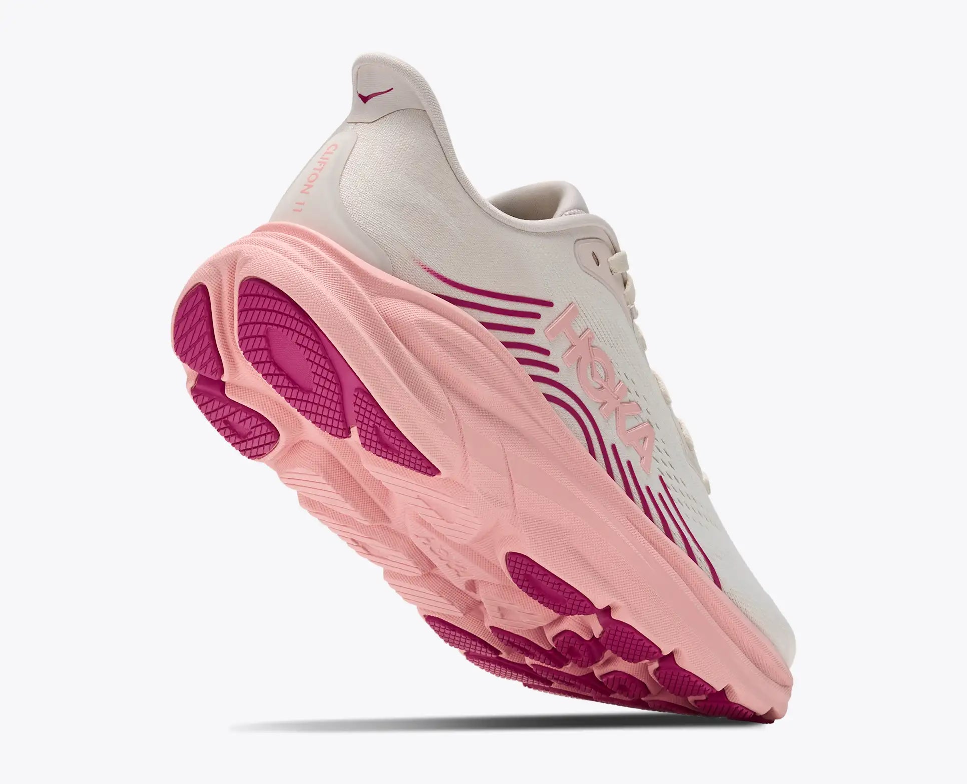 Pink and white sneaker with visible brand logo on a white background