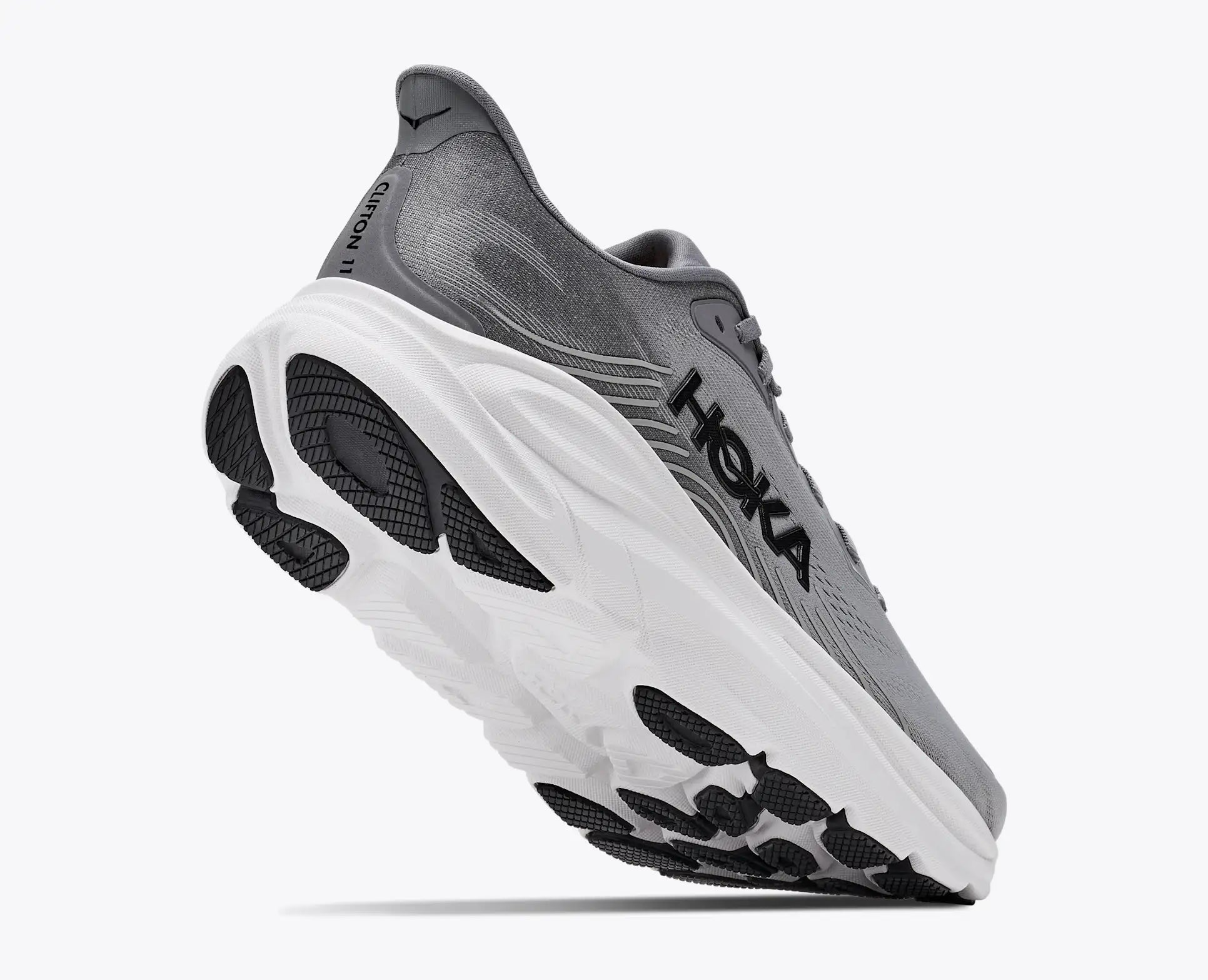 Gray running shoe with white sole on a white background
