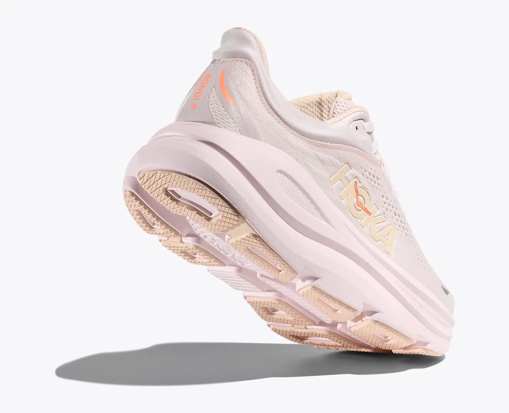 Light pink running shoe with pink sole on a white background