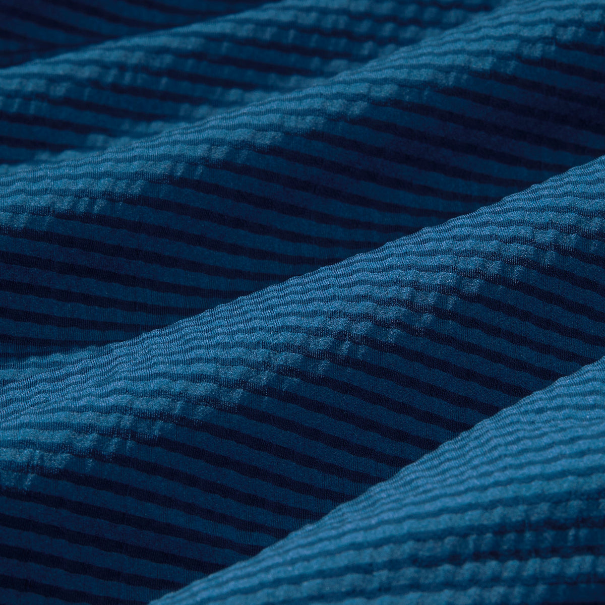 Close-up of blue textured fabric with diagonal stripes