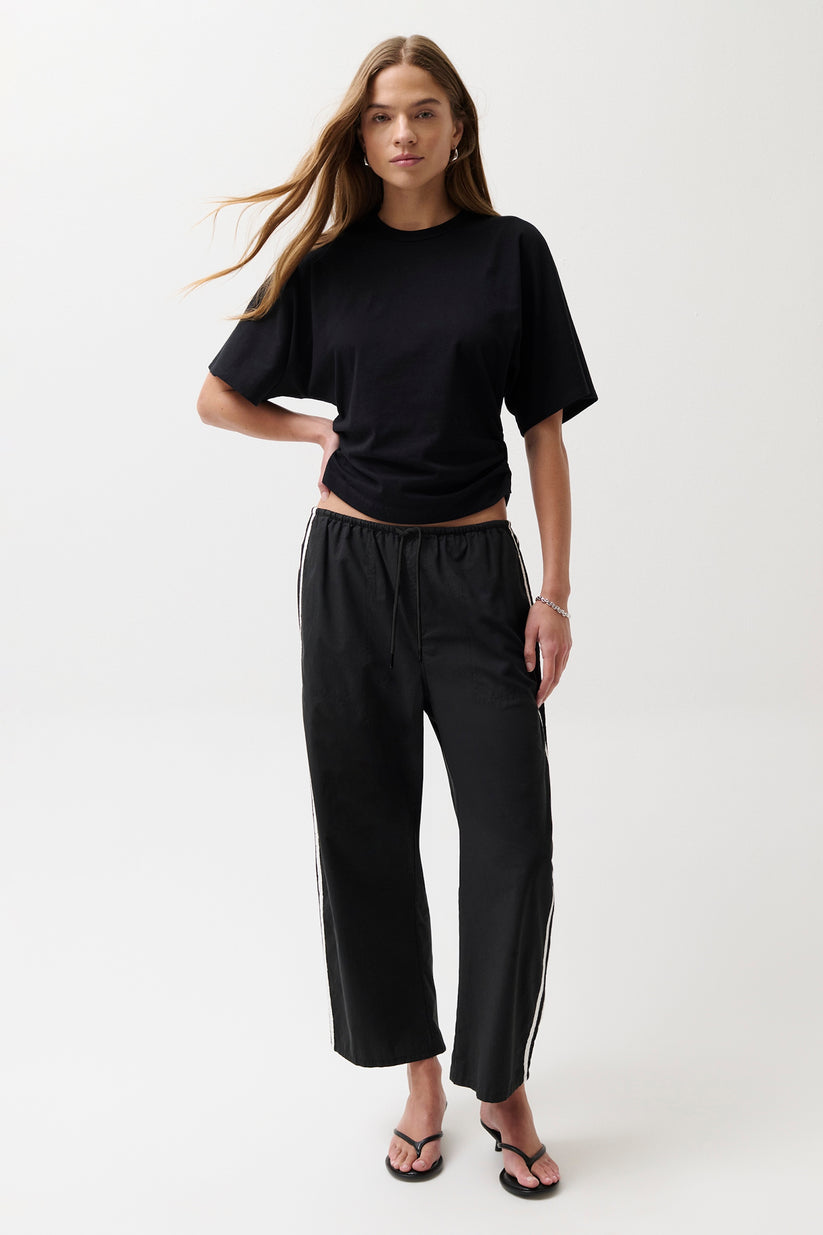 Woman wearing a black outfit with a white background